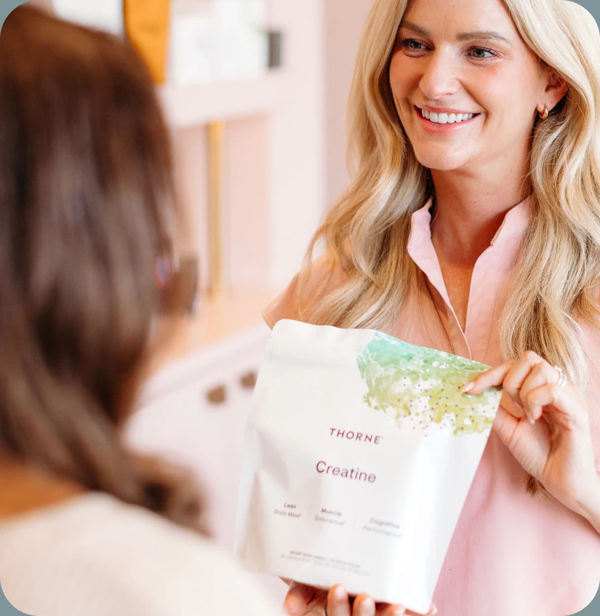 Courtney discussing a Thorne supplement with a patient